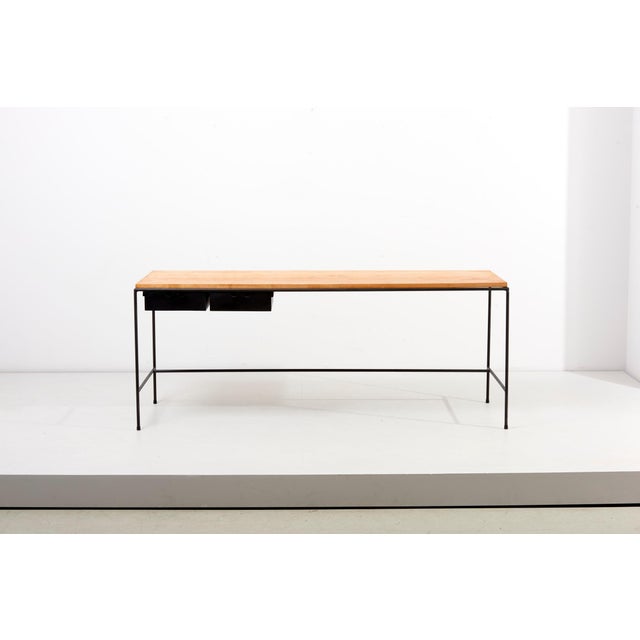 Paul McCobb console table in metal with glass top. This piece is attributed to the mentioned designer/maker. It has no...