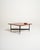 Italian-designed coffee table, 1970s. Teak top and black lacquered metal frame with metal ends. The brand is stamped on...