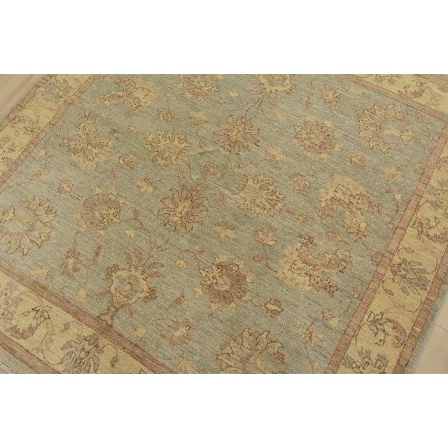 A traditional Ziegler rug hand-knotted with fine wool on a cotton foundation. This rug features a subtle botanical design...