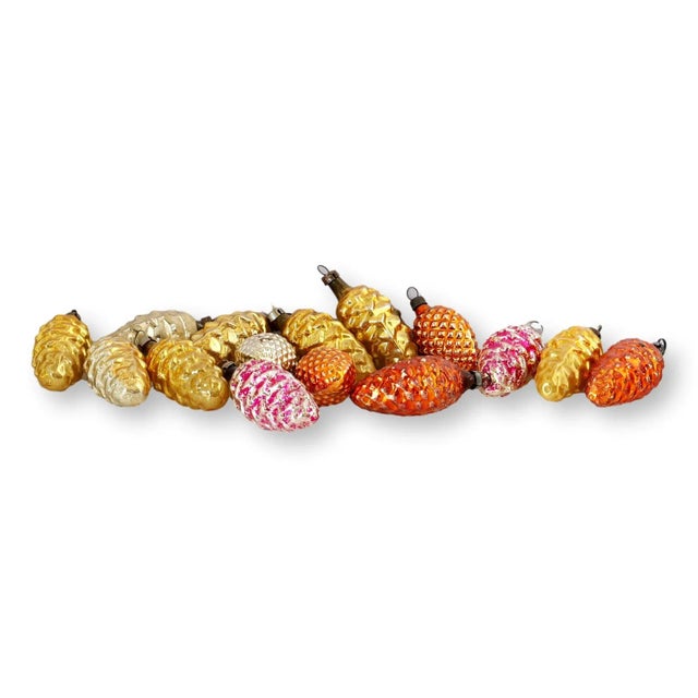 Golden glow meets woodland chic. This shimmering set of 15 midcentury mercury glass pinecone ornaments brings both rustic...