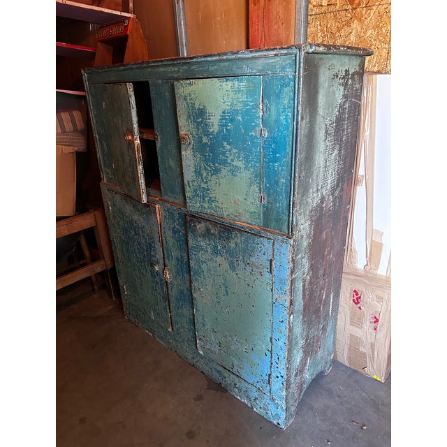 Beautiful statement piece. Bright and faded chippy wood in different shades of blue. Four doors and lots of cabinet space....