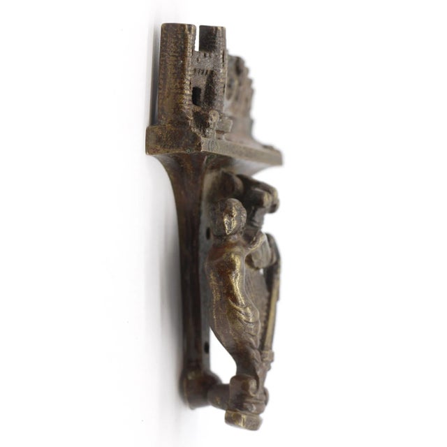 Small brass door knocker stamped Conway Castle & Bridge with castle, bridge, and city details with an angel and harp on...