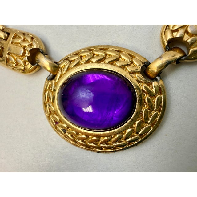 Trifari 80s panther link necklace with center purple lucite cabachon. 17.5” from end to end.