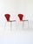 A pair of original Lennart Bender chairs, featuring a distinctive design with tubular metal legs and a red painted wooden...