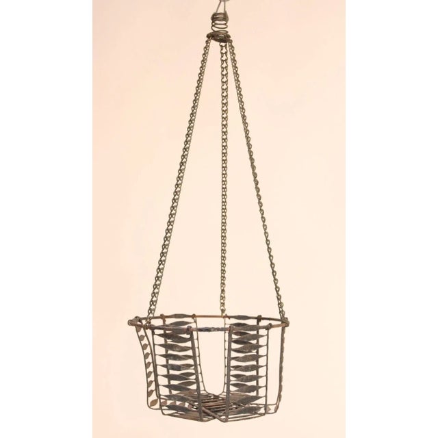 Rustic metal wire egg basket with original hook and chain (ca. 19th Century, USA). Though originally used for housing...