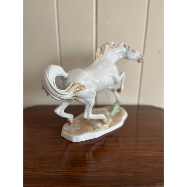 White porcelain stallion sculpture marked Wien / 27 and Made in Austria.