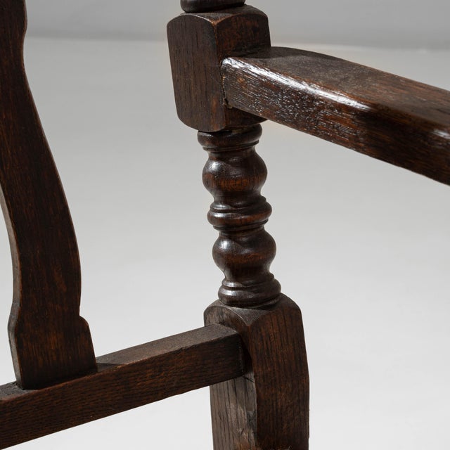 This pair of 20th Century French Baroque wooden armchairs showcases the ornate craftsmanship and sculptural detailing...