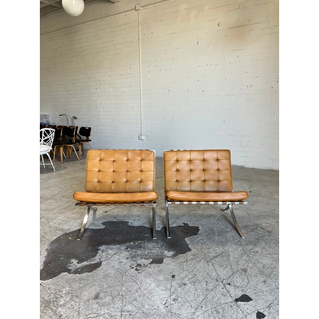 Gorgeous pair of iconic Barcelona lounge chairs designed by Mies Van der Rohe for Knoll. This pair features polished...