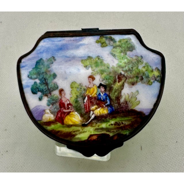 A 19th Century Enamel on Copper Patch Box, Trinket Box.. The top has an 18th Century scene with two ladies being...