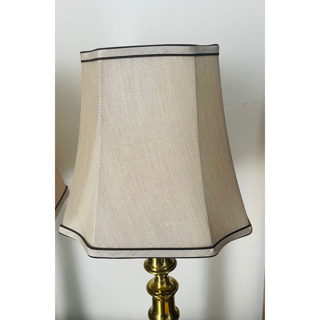 Great pair of brass table lamps with custom tan silk shades with double trim.
