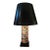 A table lamp that has a cylinder shaped body that is hand painted with a series of square shaped iimages that are...