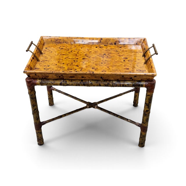 Vintage Maitland Smith tray table. Features a tortoise-finished bamboo base with leather straps. The removable tray top...
