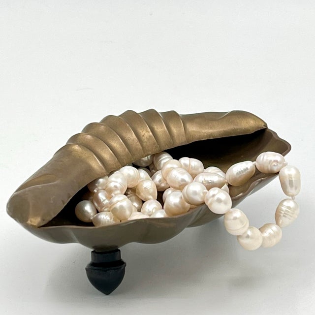 Vintage 1970s Brass Scallop Shell Ashtray can also be used as a soap or trinket dish. This heavy brass shell features...