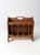 This vintage wooden magazine rack features classic spindle detailing, a rich wood finish, and a built-in handle for easy...