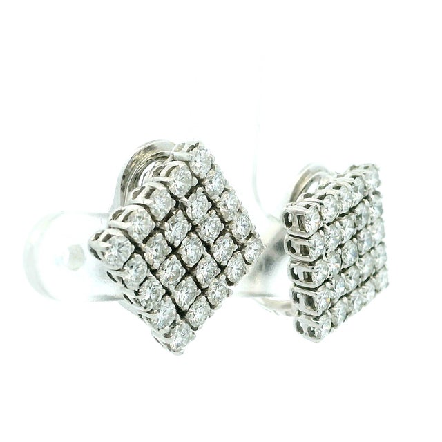 A chic and timeless pair of Italian diamond cluster earrings, crafted in 18 karat white gold and dating to the 1990s....