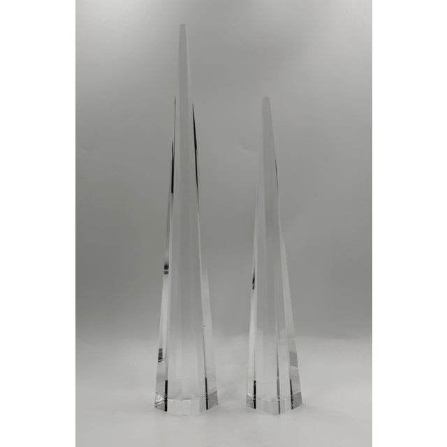 A striking pair of vintage Lucite obelisk sculptures designed and manufactured in the United States by Charles Hollis...
