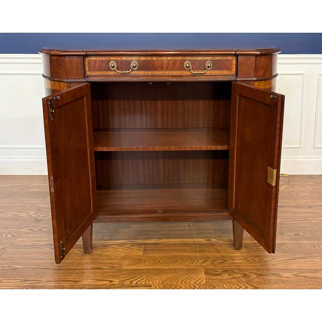 This is a Hepplewhite style Console/Storage Cabinet by Leighton Hall. It features swirly crotch mahogany drawers and...