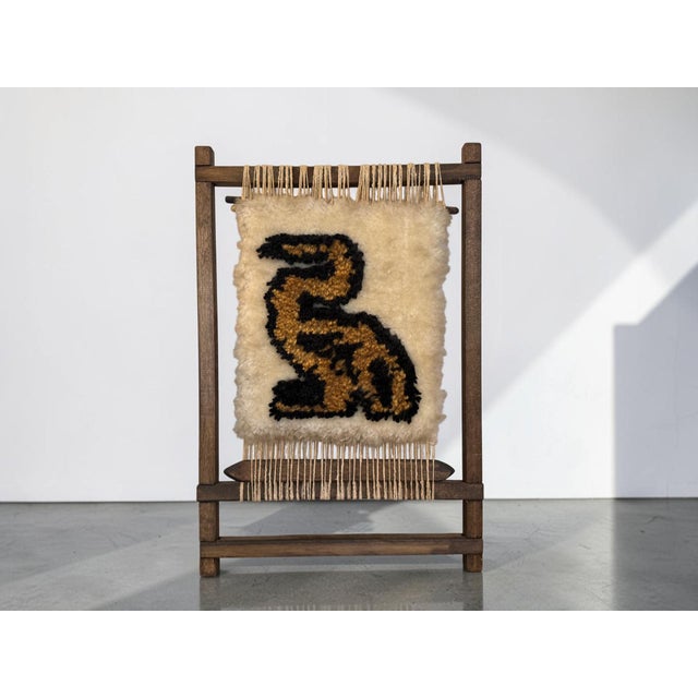 Really unique vintage fiber art piece with a stylized animal design woven in black and warm golden brown against a soft...