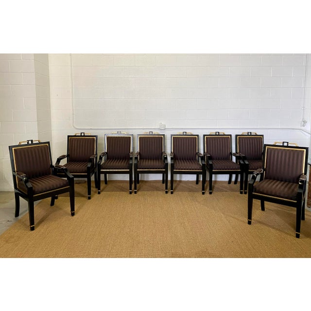 We are very pleased to offer a regal set of eight dining chairs, circa the 1980s. The chairs' square back design showcases...