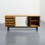 Cansado sideboard with an ash veneer body, opening with two sliding doors covered in black and white laminate and four...