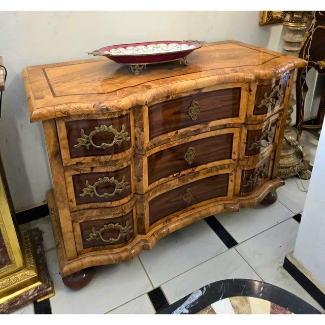 Make an unforgettable statement with this Grand French Bombe Chest of Drawers, a masterpiece of craftsmanship designed to...