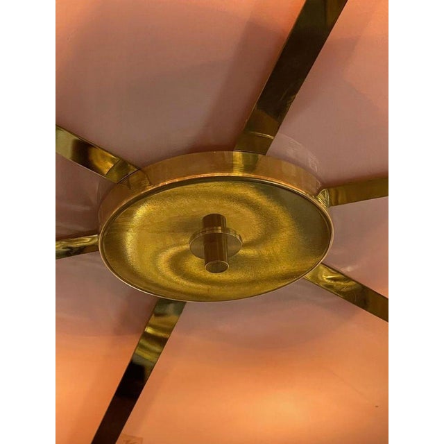 Modern Murano disc chandelier with pink and champagne glass on a brass frame. Great lines and style appropriate for any...