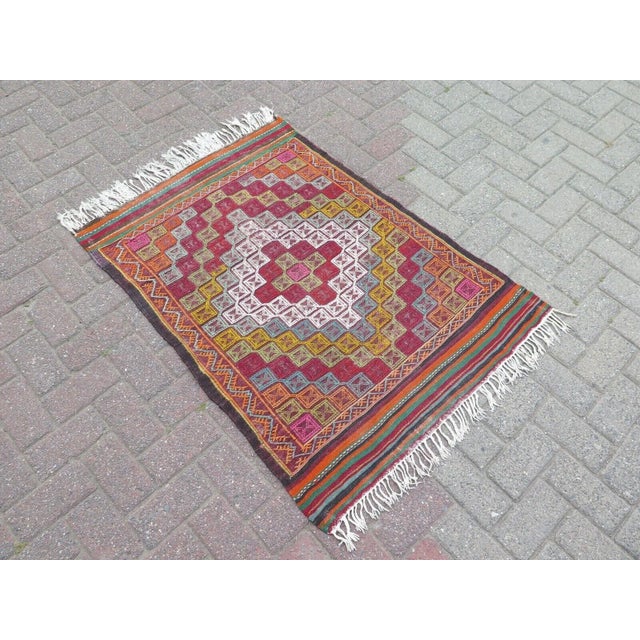 This beautiful, traditional vintage, flatweaved Turkish kilim rug is approximately 60 years old. It is handmade of very...