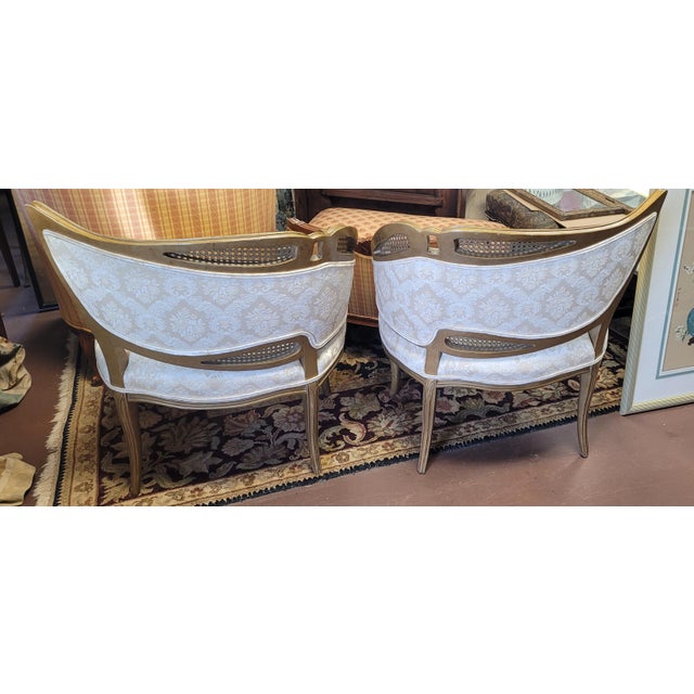Fine matched pair of Italian Rococo style 1950s Hollywood Regency Bergere Leaf chairs. Each features clean white...