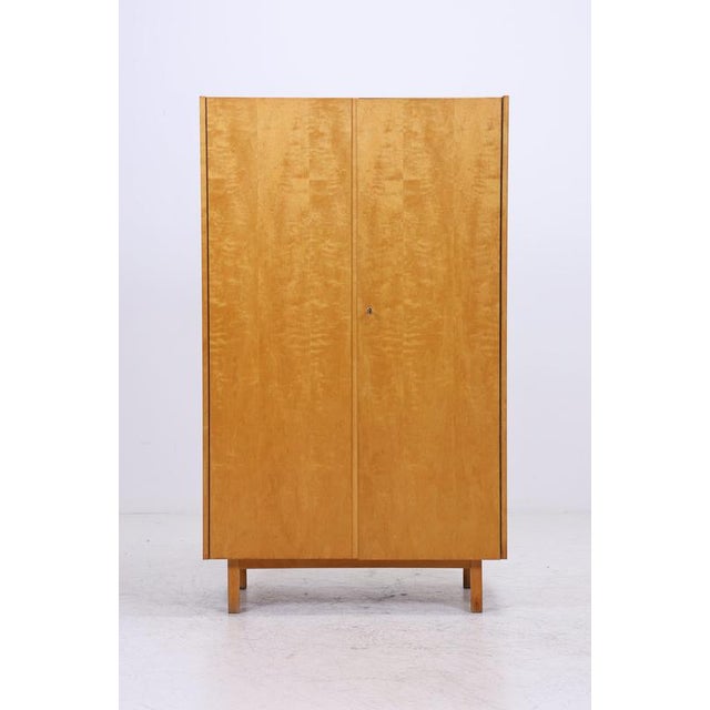 Vintage wardrobe model 794/1 from Deutsche Werkstätten Hellerau, dating from 1967. The striking birch front with its...