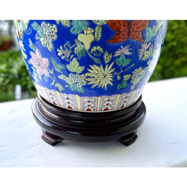Vibrant Cobalt Chinoiserie Ginger Jar with Butterflies + Carved Hardwood Stand A striking cobalt‑ground chinoiserie ginger...