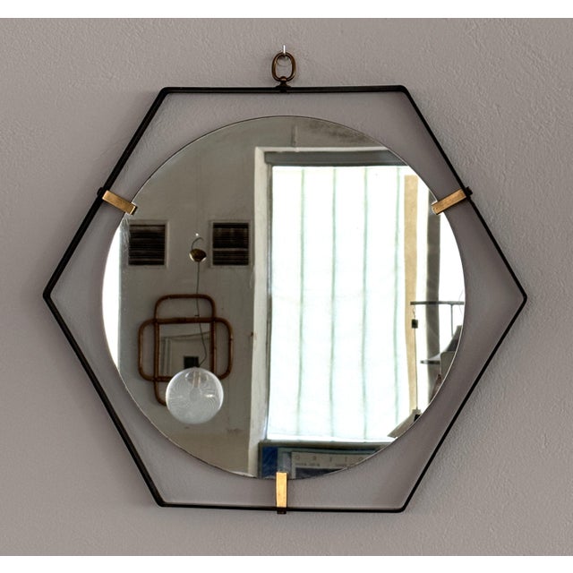Gorgeous floating wall mirror from the Italian mid-century in hexagonal shape, manufactured by Santambrogio & De Berti....