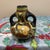 A charming example of early 20th-century Japanese art pottery, this small, double-handled gourd-shaped vase features hand-...