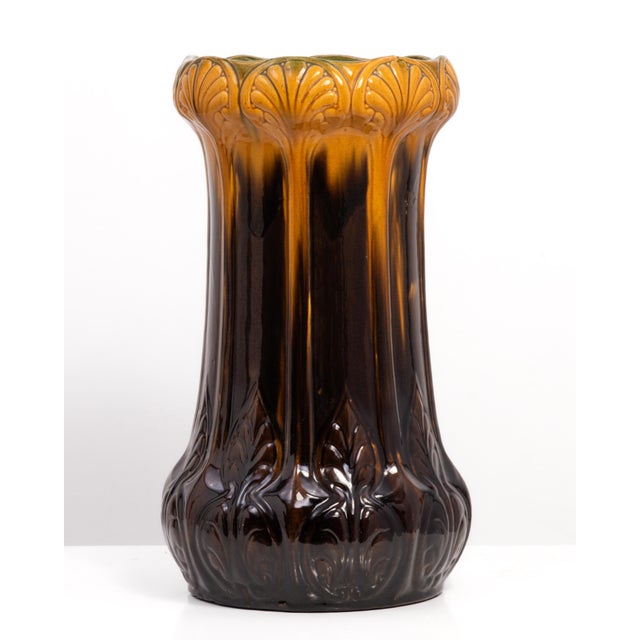 A very nice Art Nouveau umbrella stand attributed to McCoy Pottery. Green interior with mustard flowers that flow to brown...
