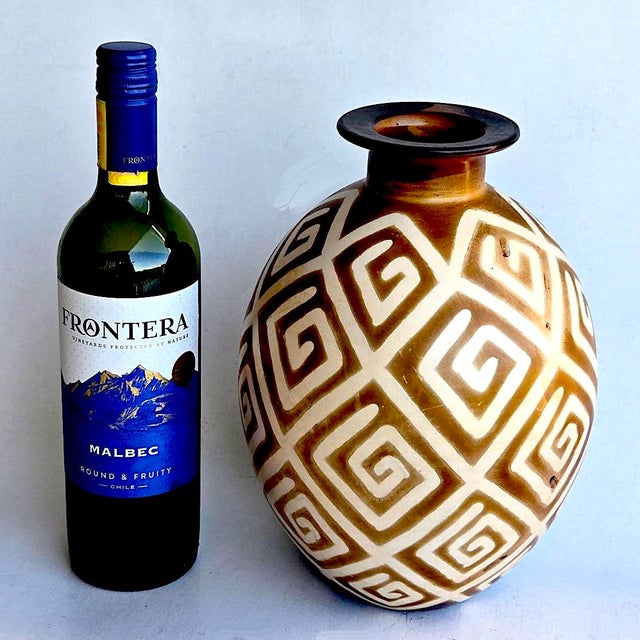 Offered is a hand decorated Peruvian ceramic vase made at the Chulucanos studio in Peru and signed "Luis Salas - 2003"....