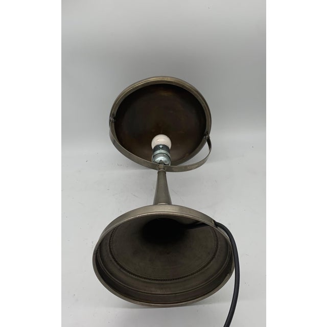 This Art Deco table lamp is an example of clean and functional design. It is crafted from dark gray metal, brushed brass,...