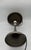 This Art Deco table lamp is an example of clean and functional design. It is crafted from dark gray metal, brushed brass,...