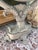 Beautiful vintage Hollywood Regency tabletop vanity mirror featuring an elaborate silver-tone cast metal frame adorned...