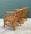 This exquisite pair of vintage rattan lounge chairs features a striking diamond-lattice or trellis design that...