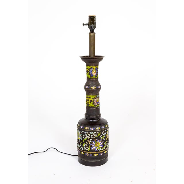 An early 20th century, black patinated, cast bronze and champleve enamel lamp; in an elongated shape with intricate greek...