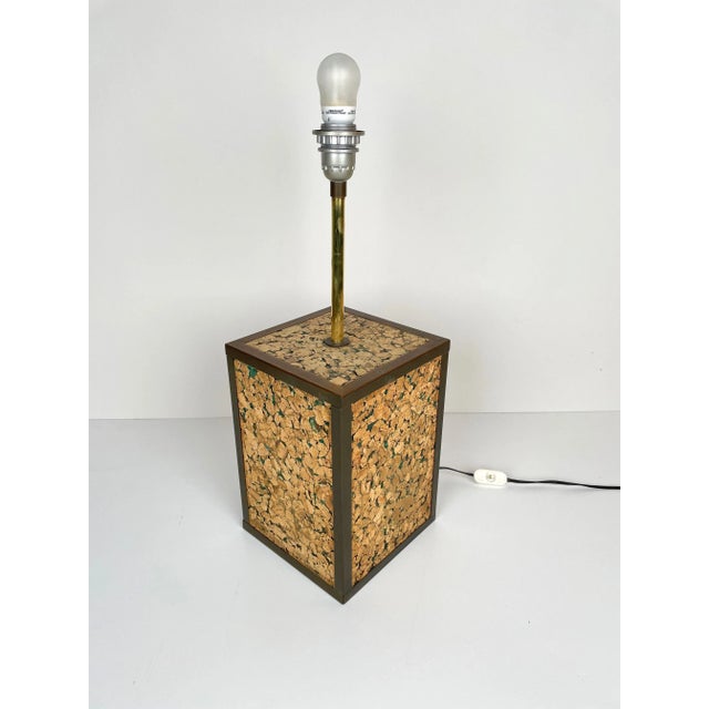 Table lamp with a particular base in cork and brass, made in Italy, 1970s. Up to 250V (Europe/UK Standard).The wiring of...