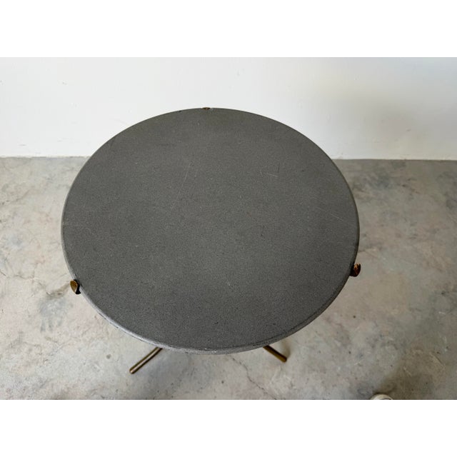 Original 1970s Cedric Hartman side table featuring a sculptural tripod bronze base with elegant, minimalist lines. The...