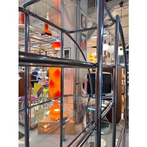 This exceptional designer shelf is a true statement piece for any interior. The striking, circular construction in chrome-...