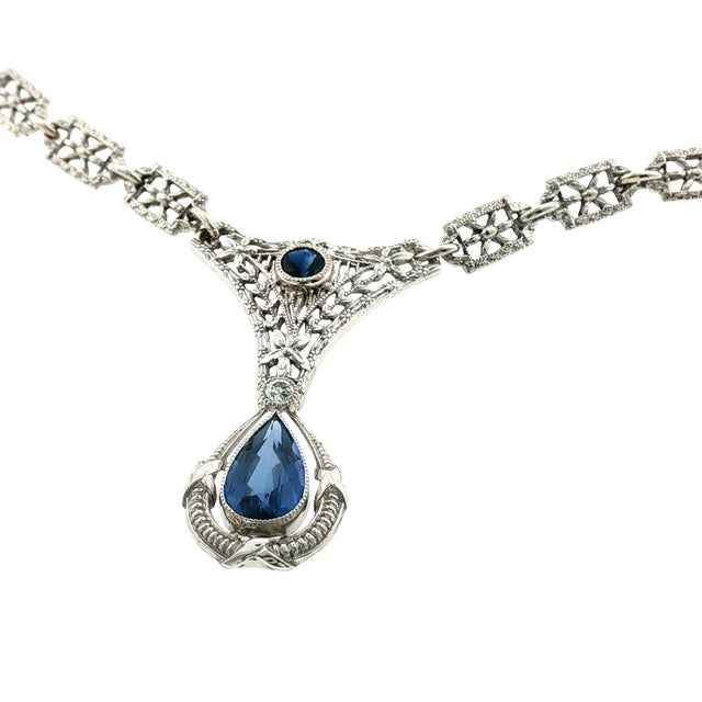 An exquisite Edwardian drop necklace featuring a stunning pear shape natural blue sapphire as the centerpiece. The...