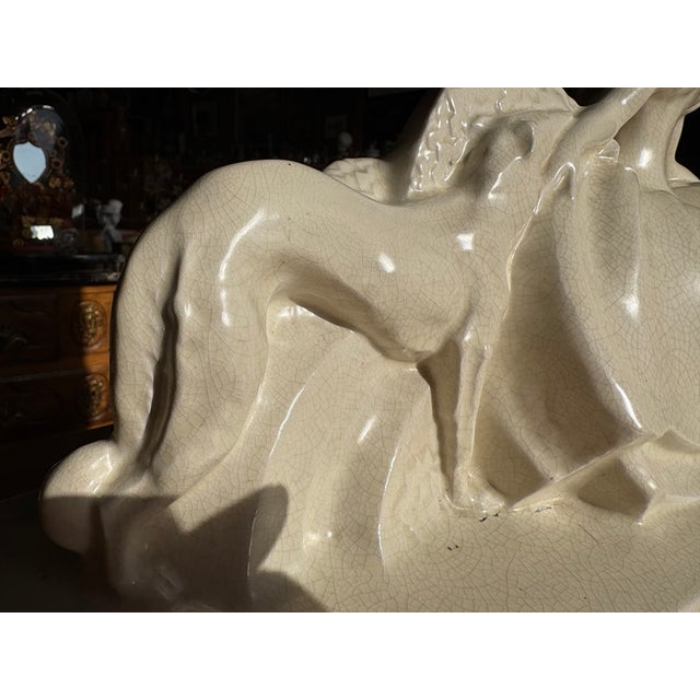 Superb art deco sculpture in ivory crackle-glazed earthenware, signed lejan, depicting an elegant woman and her greyhound....