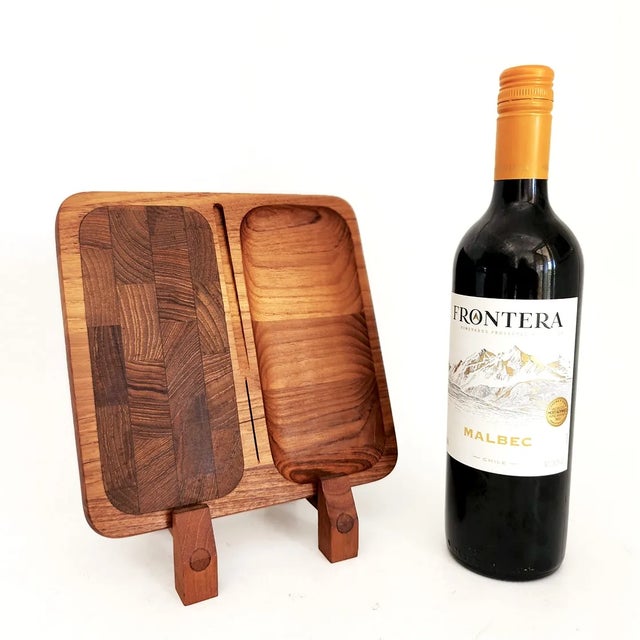 Offered is a small staved teak wood charcuterie board with a raised butcher block surface, a carved out side for cheeses...
