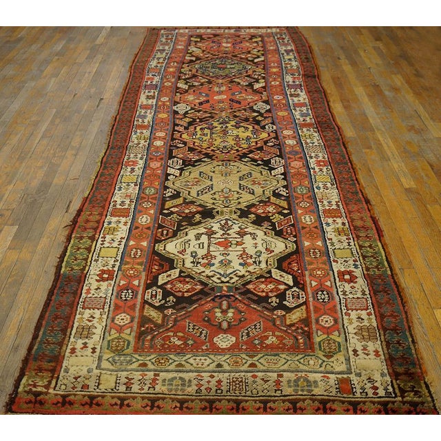 Stacked medallion design with flowers and boteh. Brown background with ivory, red, and brown borders. Hand knotted wool...