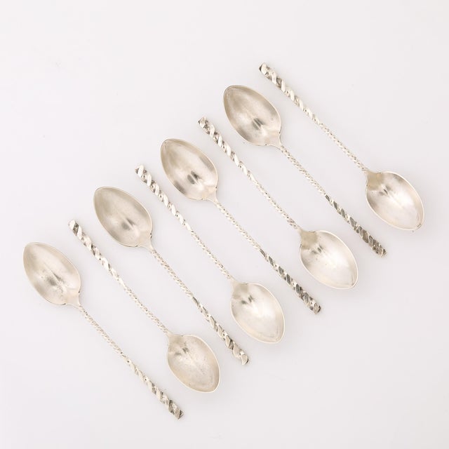This set of eight Arts and Crafts Movement Sterling Silver Square Twist Teaspoons, signed by Whiting Manufacturing Co. and...