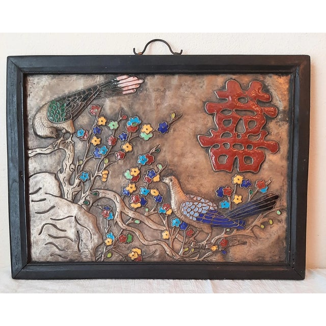 Gorgeous hand enameled Asian art. Framed in wood. This is metal with enamel art embossed and applied. There seems to be...
