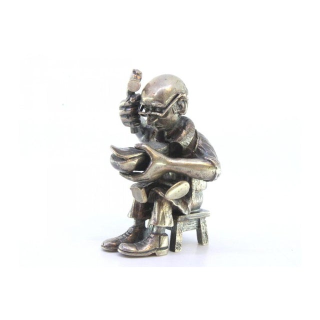 Figure of Seated Shoemaker Repairing Shoes in Silver, in Very Good conditions. Designed 1920 to 1949 This piece has an...