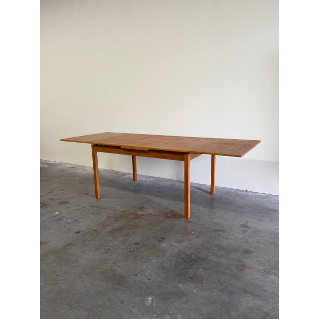 Authentic Danish extendable dining table crafted in solid teak by VSM, Denmark. This beautifully proportioned table...